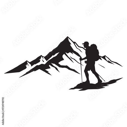 Hiker with poles in front of jagged mountain silhouette