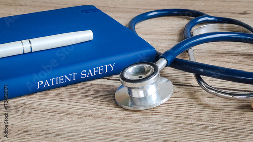 A pen and stethoscope on a book titled 