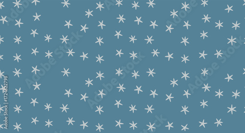 Gentle white snowflakes fall softly on a muted blue background