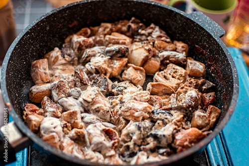 fried porcini mushrooms with sour cream in a frying pan