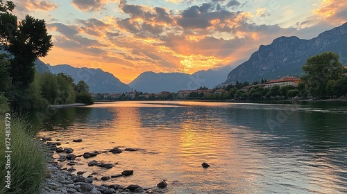 Breathtaking view of River Adda with surrounding mountains and a dramatic sky in Lecco, Italy, at sunset