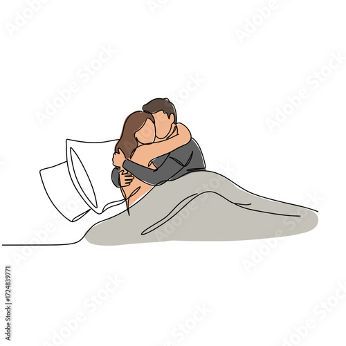 Couple embracing in bed under blanket with pillows and comforter  