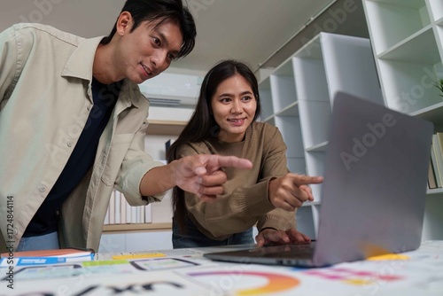 Engaged Designers Analyzing UX UI Designs on Laptop