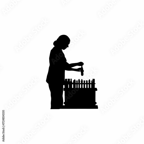 Silhouette of lab worker placing blood tube into rack isolated on white background