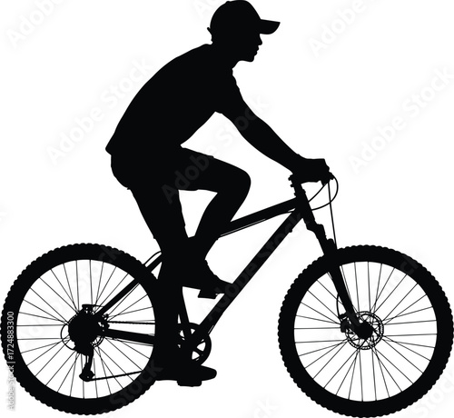 Silhouette of a man riding a mountain bike with cap and confident posture