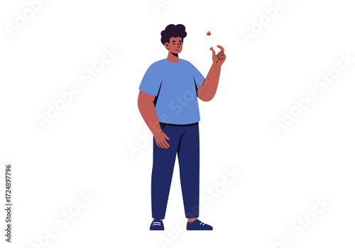 A person of color stands and gazes at a small, floating red object.