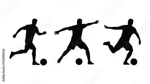 Silhouettes of soccer players in action kicking a ball