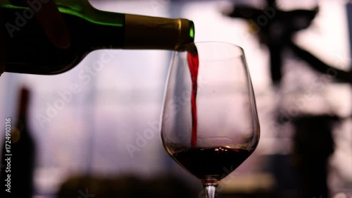 Red Wine Being Poured In Rainy Atmosphere, Red wine flows gracefully into a glass amidst a rainy backdrop, creating a moody ambiance, perfect for a romantic film scene or a sophisticated wine ad.