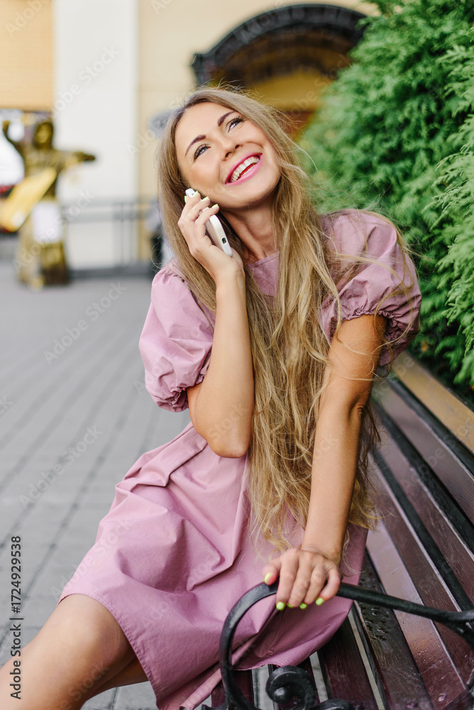Fototapeta premium Beautiful Smiling Woman Talking On Smartphone Outdoors