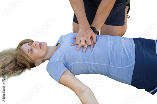Person performing cpr on unconscious woman heart attack