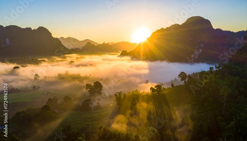 Sunrise over misty valley, illuminating lush greenery and distant mountains