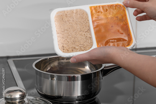 Fotografie Dinner ready to be heated in a tightly closed plastic container, with rice in one compartment and chicken in korma sauce in the other