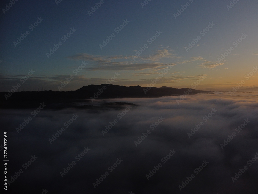 Fototapeta premium Golden Sunrise Over the Clouds Captured from a Drone – Aerial Landscape ViewDescription Beautiful sunrise above the clouds taken from a drone, showing a dramatic and scenic aerial landscape.