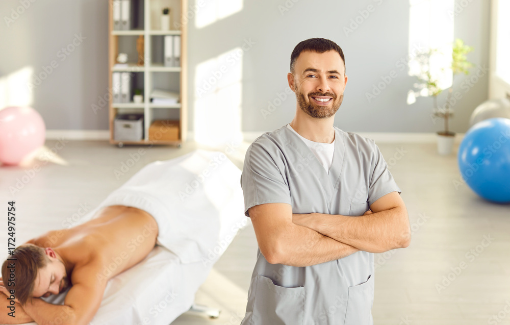 Obraz premium Portrait of a happy man, masseur and physiotherapist, in a massage salon. He embodies the role of a healthcare provider, delivering medicine and healthcare services with a caring attitude.