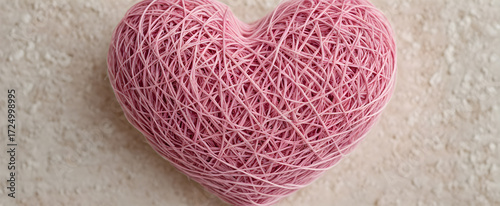 Pink twine heart handmade decoration. Romantic gift pink string heart ornament. Cozy love symbol in  rope heart. Warm decor with string heart shape.