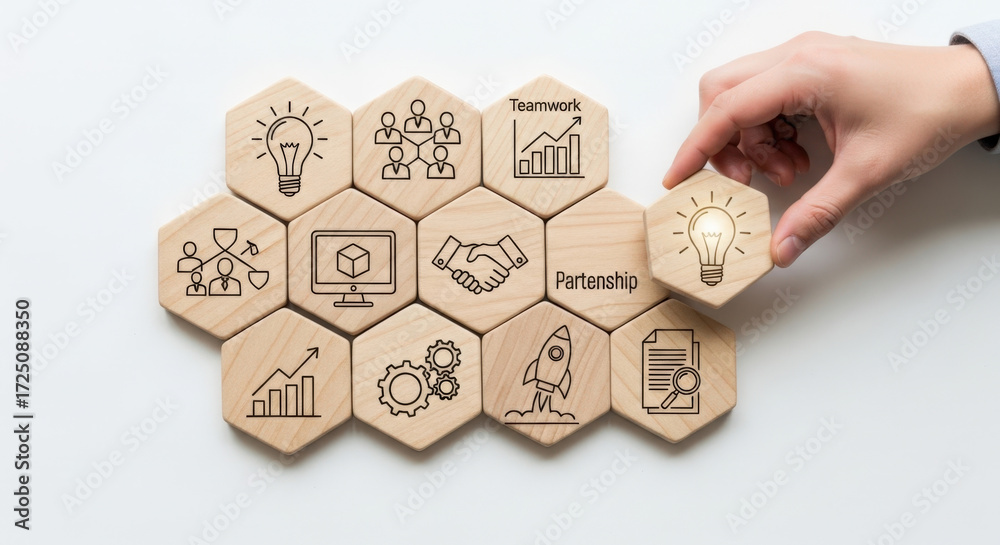 Fototapeta premium In a professional business setting, a human hand positions a wooden hexagon with an illuminated light bulb idea symbol, showcasing innovation with natural wood tones.