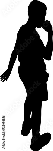 Silhouette of a young  boy walking while eating 