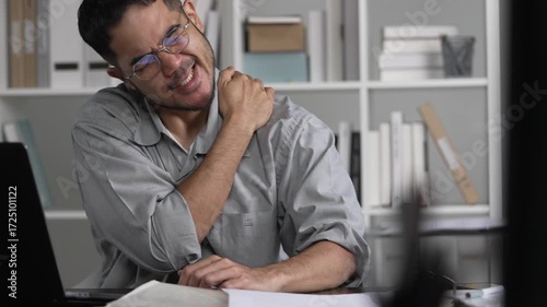 Businessman having neck ache and shoulder pain from working in the office
