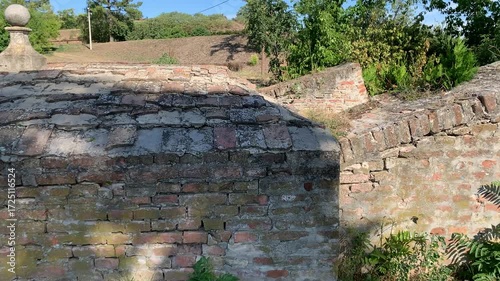 An old, monumental brick wall sample that requires partial repair and cleaning