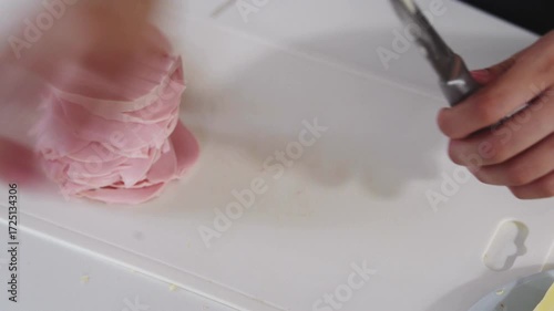 A young woman prepares fresh sandwiches with butter, sausage, and cheese on crispy bread. Close-up shots showcase the appetizing food preparation process in a modern kitchen