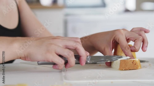A young woman prepares fresh sandwiches with butter, sausage, and cheese on crispy bread. Close-up shots showcase the appetizing food preparation process in a modern kitchen