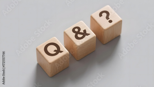 Wooden Cubes with Question Mark, Ampersand, and Letter Q on Light Gray Background
