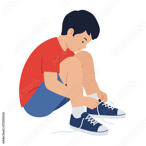 Young boy tying his shoe laces, sitting down
