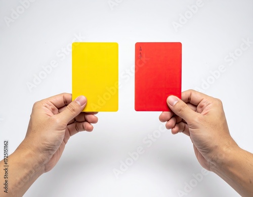 Two hands hold a yellow and red card (14)