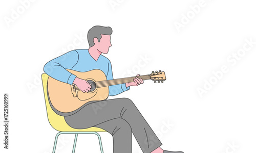 Young man serenely playing acoustic guitar while seated on a modern chair, creating a peaceful and artistic moment.