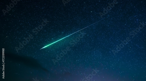 Green meteor streaking over mountain range at night.