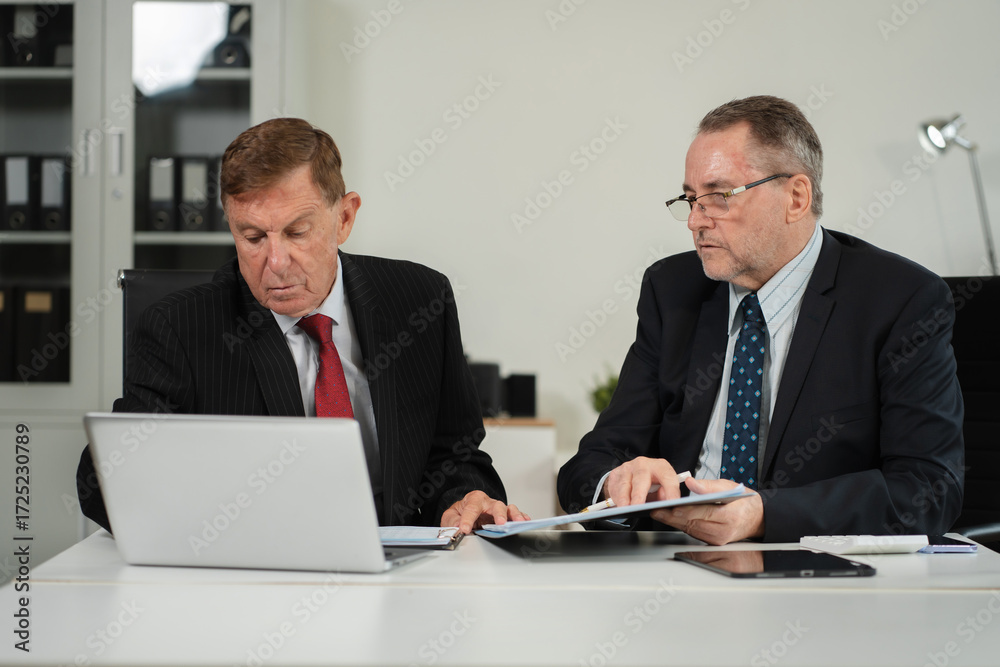 Fototapeta premium Caucasian business team working at office with laptop and documents on desk, financial adviser analyzing data.