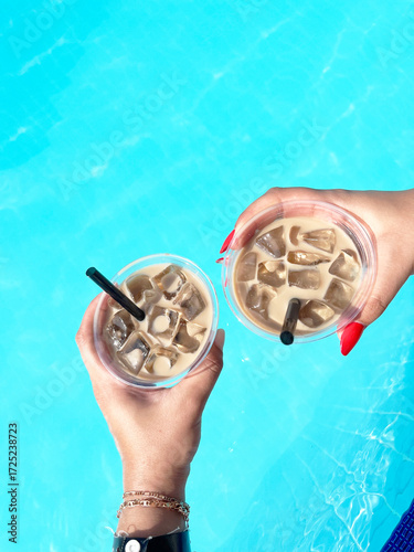 sitting by the hotel pool in the summer with glasses of cold iced coffee, Summer vacation concept