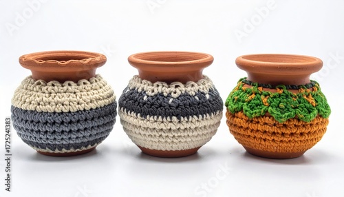 Three Brown Clay Pots with Colorful Crochet Covers on White Background