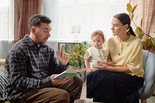 фотографія Caucasian middle aged man reading book aloud while gesturing, sitting beside you