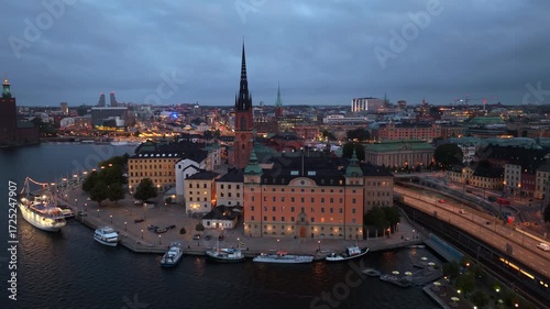 Drone video of Stockholm old town at night with night illumination, evening aerial view of Stockholm, the capital of Sweden, travel in Scandinavian countries