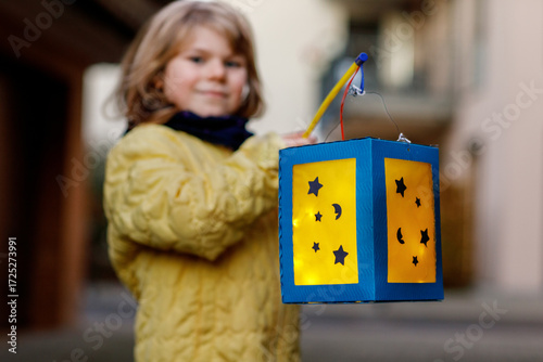 Little Preschool Kid Girl Holding Selfmade Traditional Lanterns with Candle for St. Martin Procession. Child Happy about Children and Family Parade in Kindergarten. German Tradition Martinsumzug.