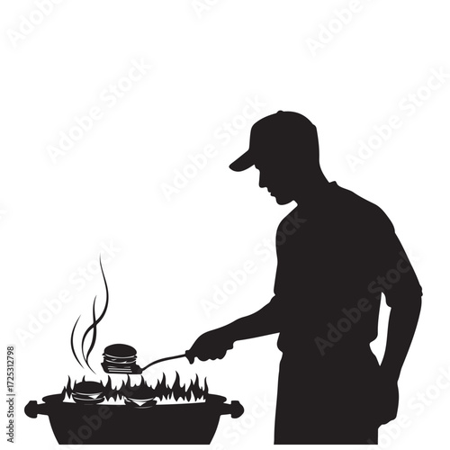 Silhouette of a Man Grilling Burgers on a Barbecue with Flames