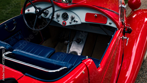 Open door detail of vintage red convertible car