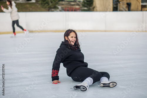 Teen girl laughing after slipping on ice
