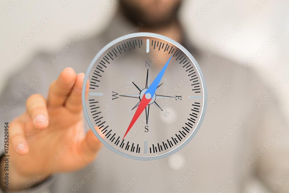 Fototapeta premium Stock photo of a hand interacting with a digital compass, showing direction and guidance.