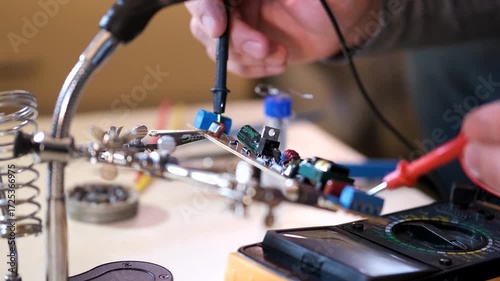 Close-up of hands soldering a printed circuit board with a soldering iron in a workshop. Concept of electronics repair, technology, DIY, and microchip maintenance.