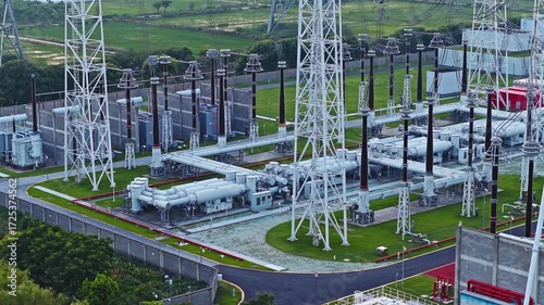 Aerial shot of a high voltage electrical power substation with transmission towers for electricity generation and distribution