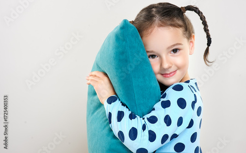 The child is a beautiful girl with wide eyes, look away in surprise. Baby in a knitted sweatshirt . Children's products , clothing and accessories . Expressive facial emotions