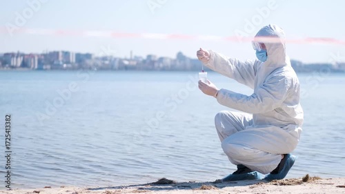 Person in protective hazmat suit and medical mask conducting water testing near lake. Environmental pollution research, contamination control, biohazard investigation, and safety inspection outdoors.