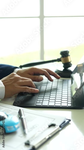 A judge holding a gavel hitting a toy car in a contract document represents automotive law, insurance disputes, car ownership, and legal decisions.