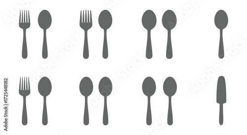 Simple arrangement of cutlery forks spoons and a knife in grayscale