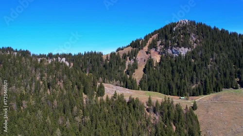 Cinematic 4K Aerial Drone video of flying over Brünnstein mountain in German Alps on a beautiful sunny summer day perfect for hiking with surrounding mountain peaks covered in ice and snow