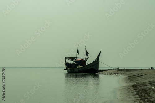 Fototapeta A coastal with sandy beaches, tidal flats, wooden fishing boats