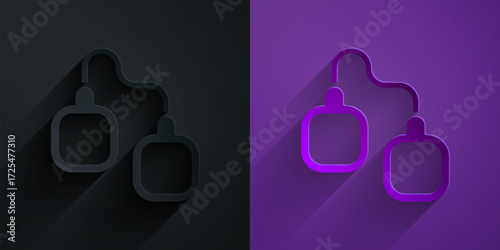 Paper cut Handcuffs icon isolated on black on purple background. Paper art style. Vector