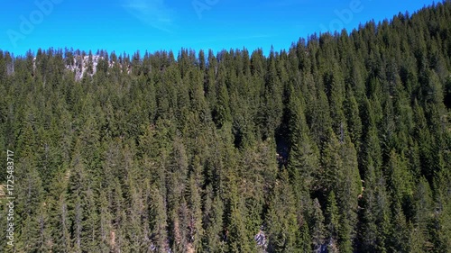 Cinematic 4K Aerial Drone video of flying over Brünnstein mountain in German Alps on a beautiful sunny summer day perfect for hiking with surrounding mountain peaks covered in ice and snow